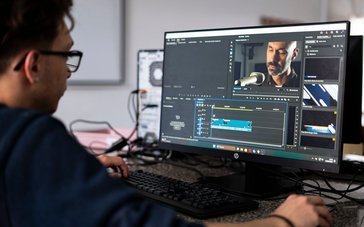 Video editor working at a desktop editing workstation