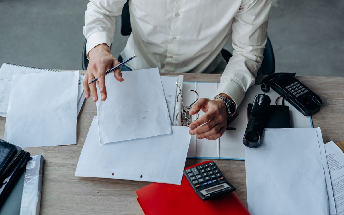 Documents and office equipment arranged on a desk