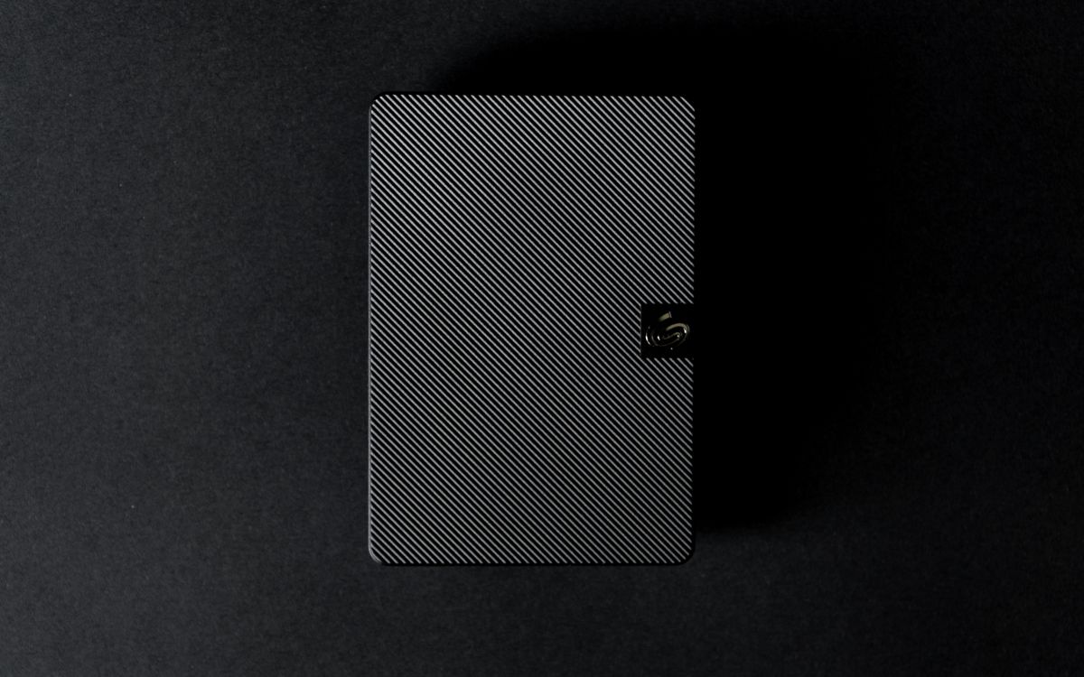 Portable external hard drive against a dark background