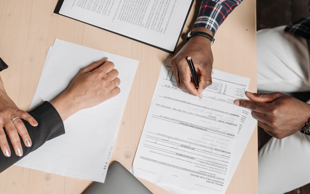 Two people reviewing documents at a shared desk