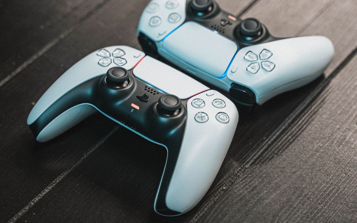 Two game controllers on a wooden table